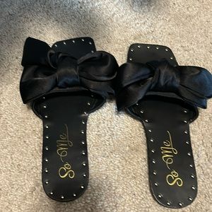 Never worn sandals. Black with bow and studs.